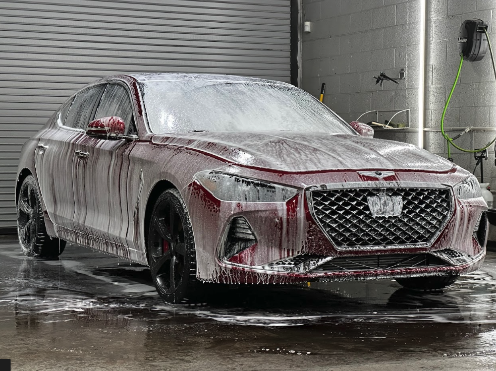 Professional hand washing a ceramic coated vehicle